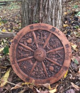 Pagan wheel resting against a tree.